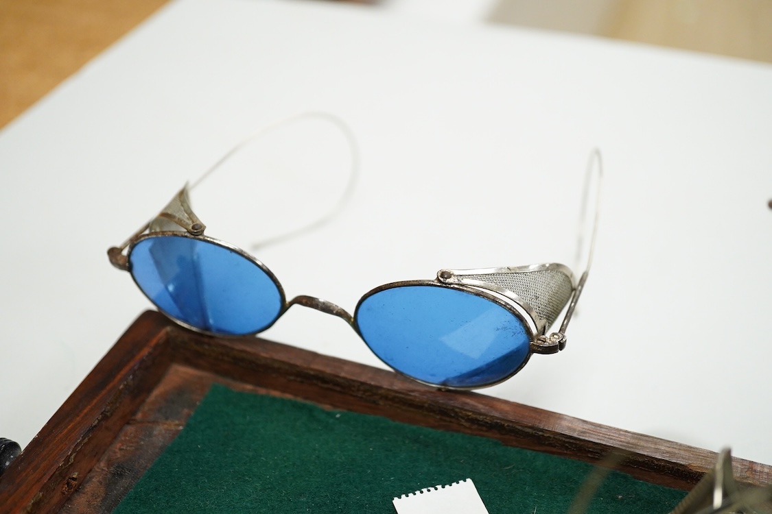 Two pairs of Willson, USA mesh sided safety glasses, and three similar pairs of unmarked glasses one in its original tin case marked BH (5)